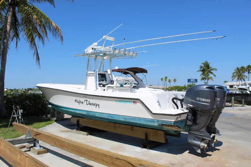  Yacht Photos Pics 2002 Contender 31 CC boat with Yamaha engines on a sunny day.