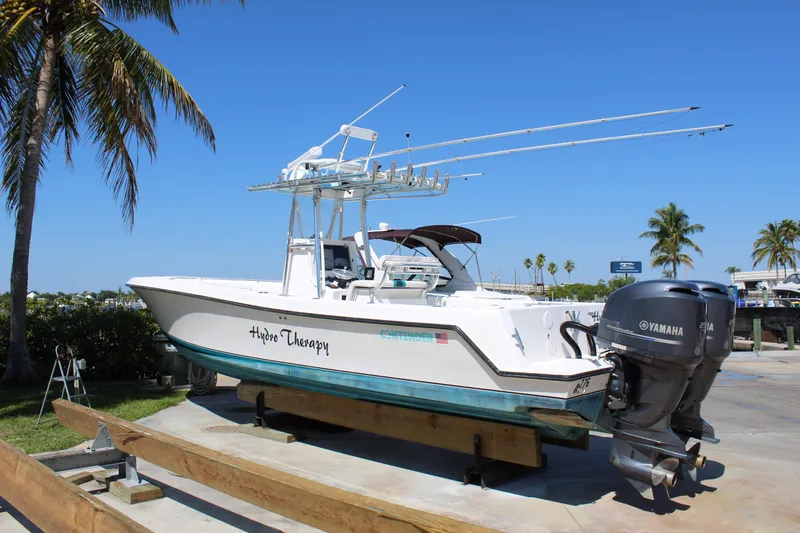  Yacht Photos Pics 2002 Contender 31 CC boat with dual Yamaha engines on a sunny day.
