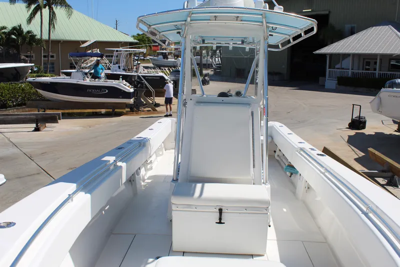  Yacht Photos Pics 2002 Contender 31 CC boat with center console, docked at a marina.