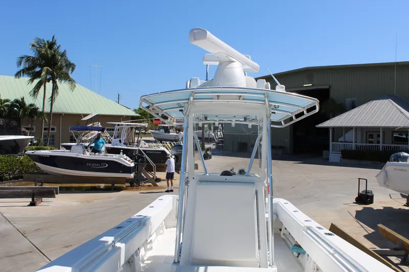  Yacht Photos Pics 2002 Contender 31 CC boat at a marina, surrounded by other vessels and buildings.