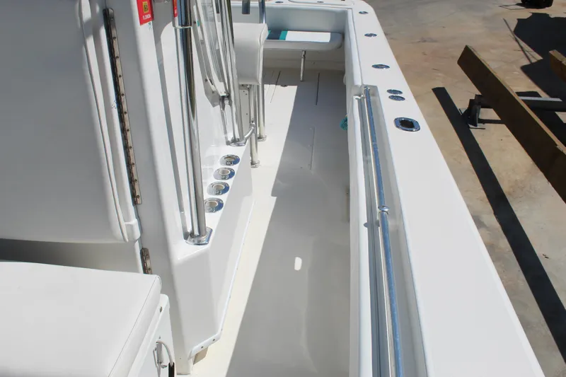  Yacht Photos Pics 2002 Contender 31 CC boat interior with rod holders and seating area.