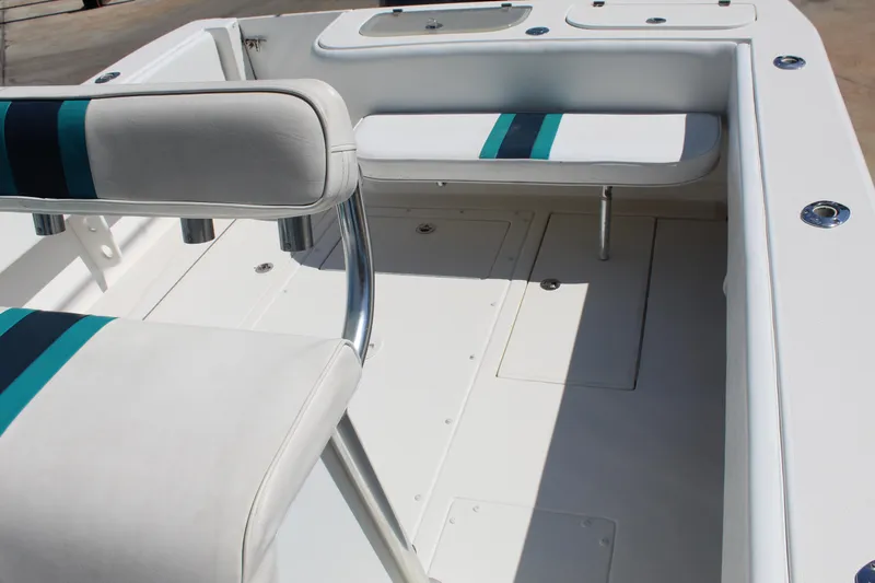  Yacht Photos Pics 2002 Contender 31 CC boat interior with white seating and teal accents.