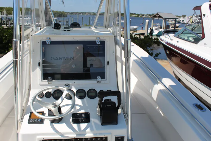  Yacht Photos Pics 2002 Contender 31 CC boat cockpit with Garmin navigation system, docked at marina.