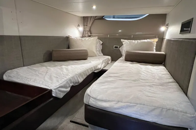  Yacht Photos Pics Twin beds in the 2017 Sea Ray Sundancer 400 cabin, featuring modern design and cozy lighting.