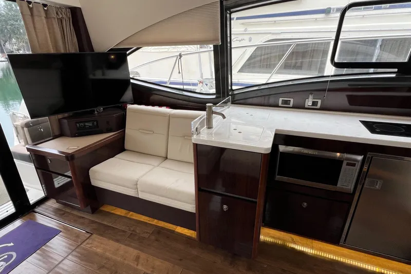  Yacht Photos Pics Interior of 2017 Sea Ray Sundancer 400 yacht with kitchenette and seating area.