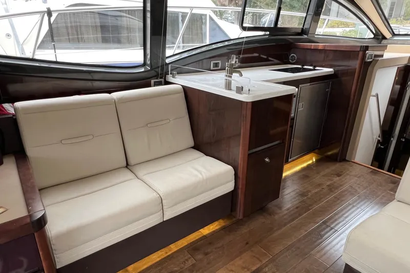  Yacht Photos Pics Luxurious interior of 2017 Sea Ray Sundancer 400 yacht with modern seating and kitchenette.