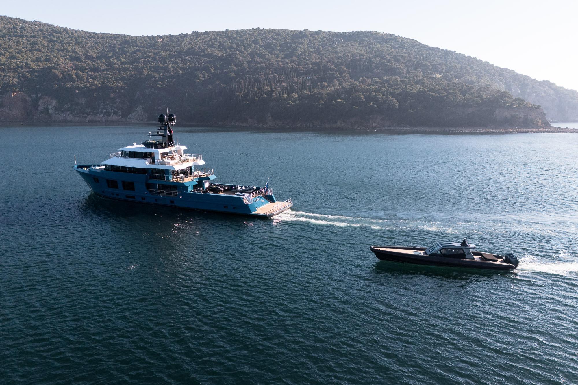 2024 Dunya Yachts Explorer cruising alongside a smaller boat in scenic waters.