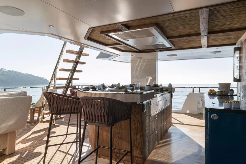 King Benji Yacht Photos Pics Luxurious 2024 Dunya Yachts Explorer interior with elegant dining area and ocean view.