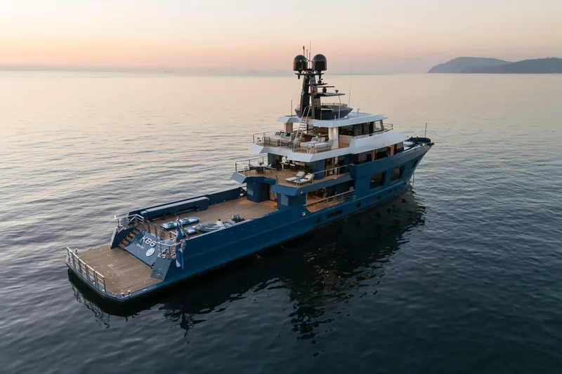 King Benji Yacht Photos Pics 2024 Dunya Yachts Explorer on serene ocean at sunset, showcasing luxury and elegance.