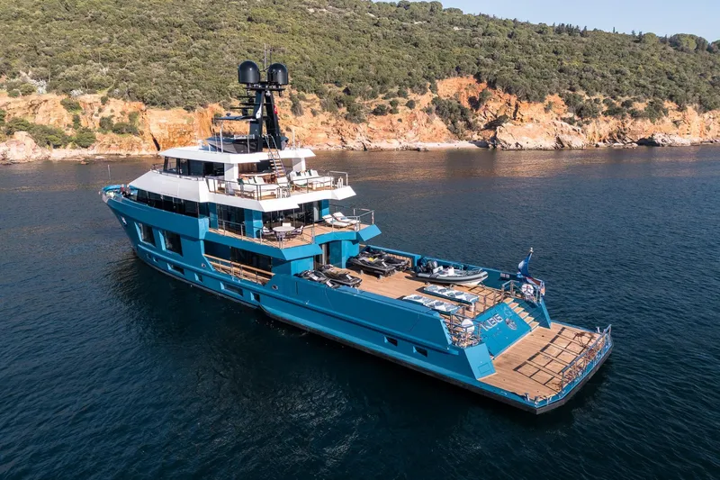 King Benji Yacht Photos Pics Luxurious 2024 Dunya Yachts Explorer cruising near rocky coastline.