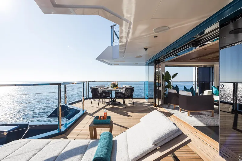 King Benji Yacht Photos Pics Luxurious 2024 Dunya Yachts Explorer deck with ocean view, featuring elegant outdoor seating.