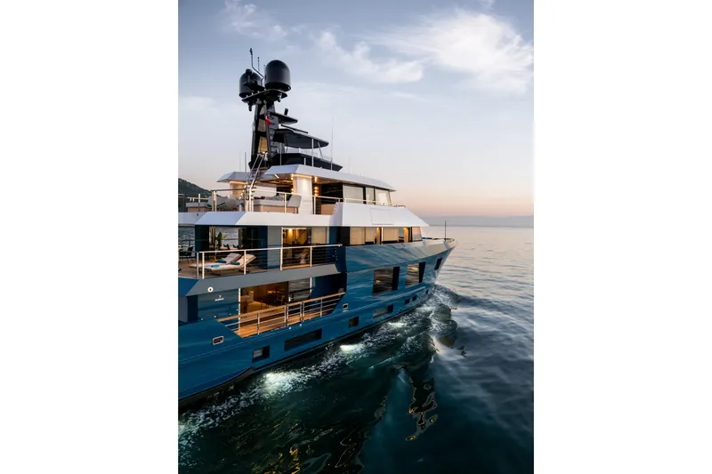 King Benji Yacht Photos Pics Luxurious 2024 Dunya Yachts Explorer cruising at sunset on calm waters.