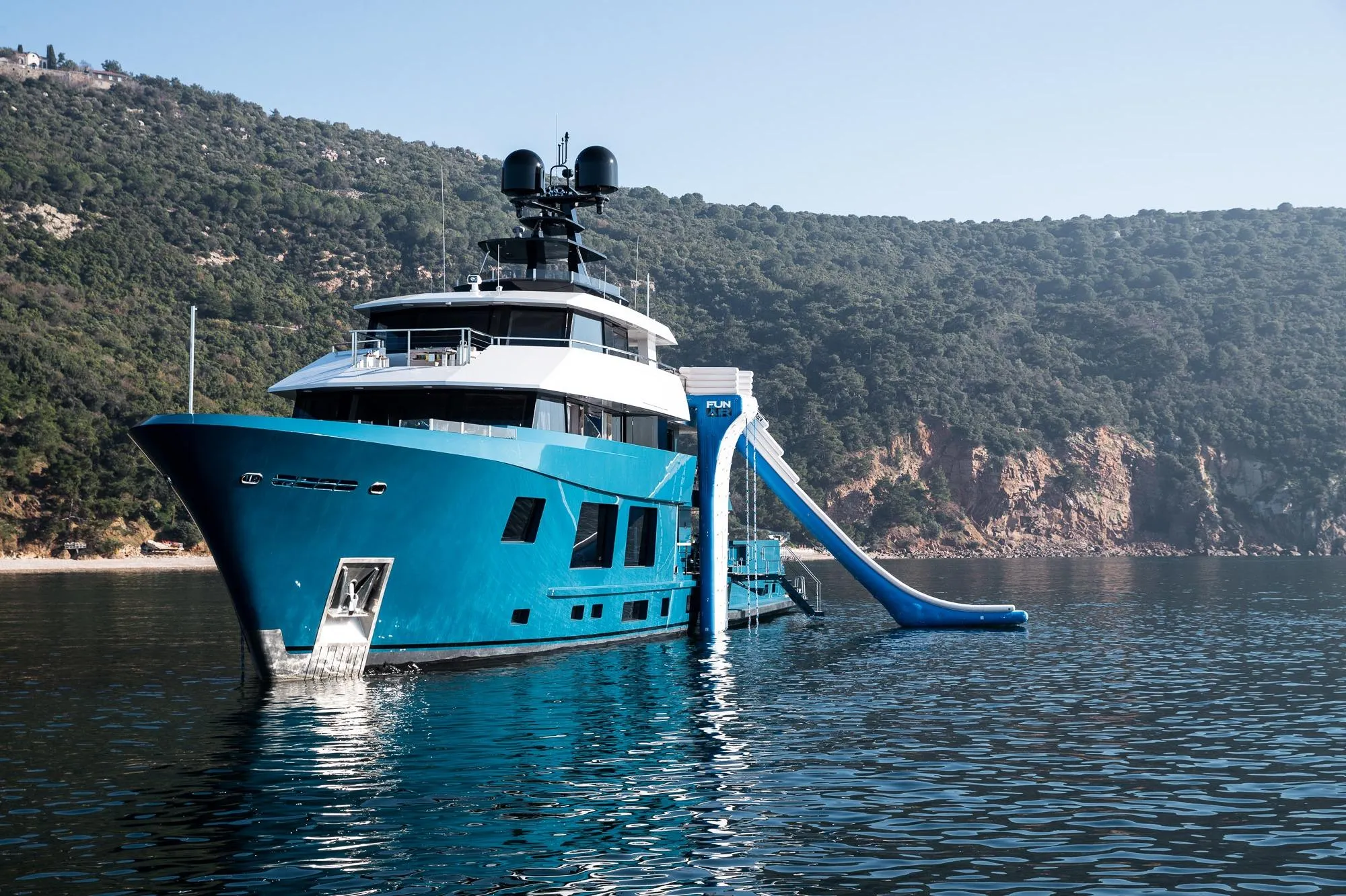 2024 Dunya Yachts Explorer with slide, anchored in scenic coastal waters.