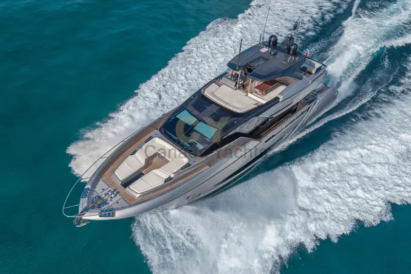 Allora Yacht Photos Pics Luxurious 2026 Riva 82' Diva yacht cruising on clear blue waters.