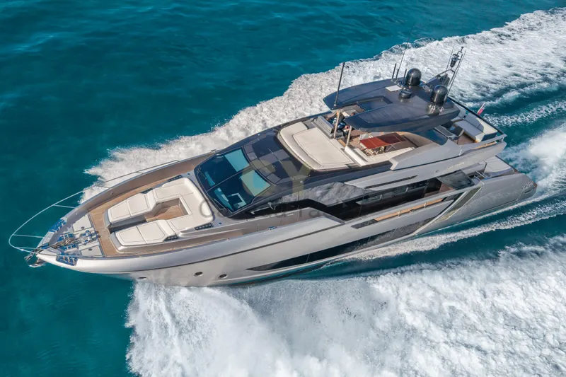 Allora Yacht Photos Pics Luxury 2026 Riva 82' Diva yacht cruising on clear blue waters.