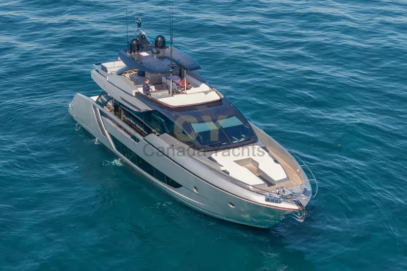 Allora Yacht Photos Pics Luxury 2026 Riva 82' Diva yacht cruising on clear blue waters.