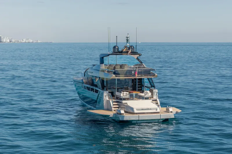 Allora Yacht Photos Pics Luxurious 2026 Riva 82' Diva yacht cruising on calm ocean waters.