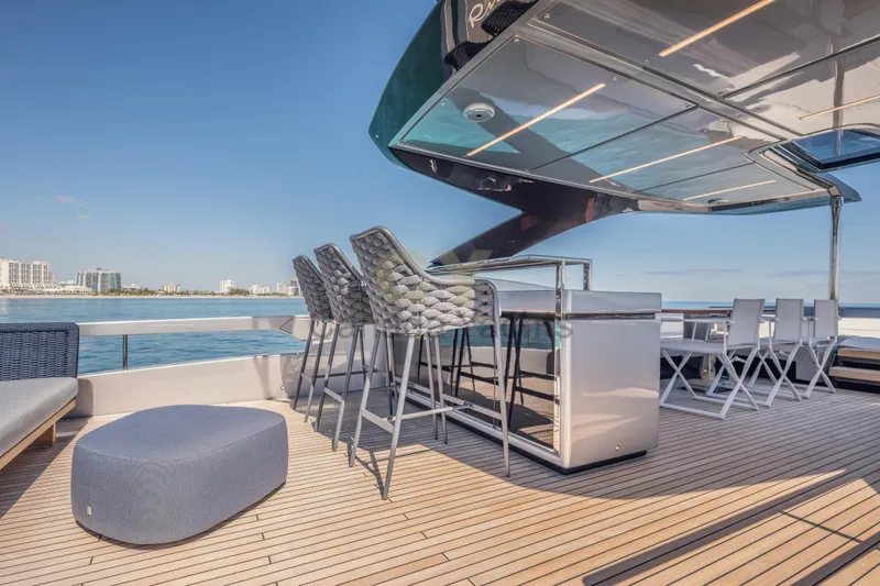 Allora Yacht Photos Pics Luxurious deck of 2026 Riva 82' Diva yacht with bar and seating area.