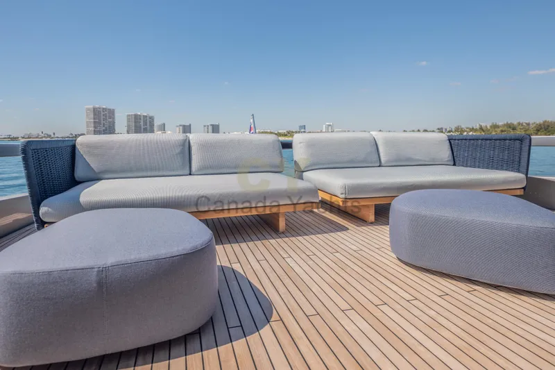 Allora Yacht Photos Pics Luxurious deck seating on 2026 Riva 82' Diva yacht with city skyline view.