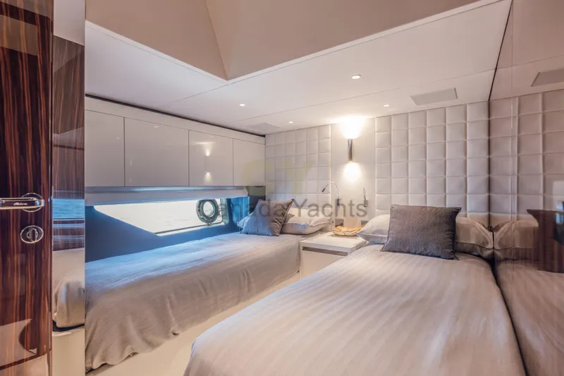 Allora Yacht Photos Pics Luxurious cabin interior of 2026 Riva 82' Diva yacht with twin beds and modern decor.