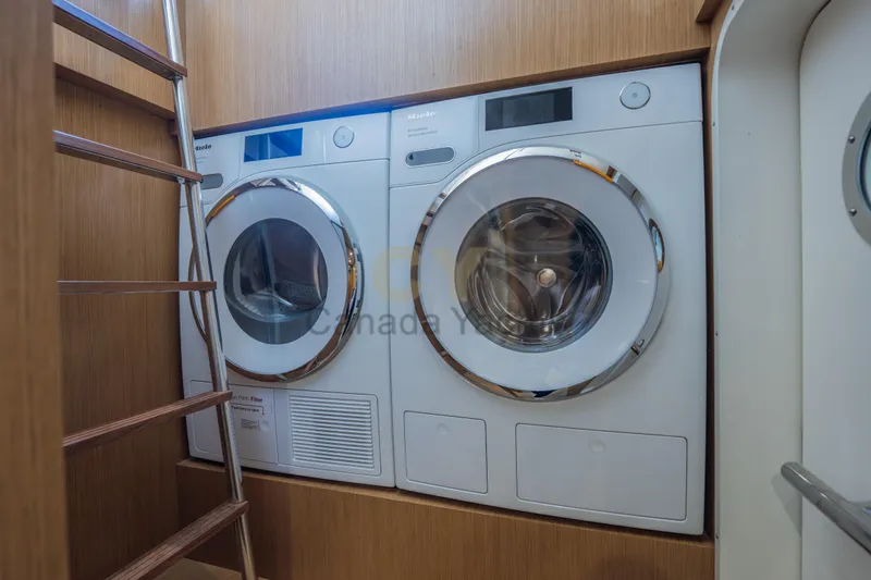 Allora Yacht Photos Pics Laundry area with modern appliances on the 2026 Riva 82' Diva yacht.