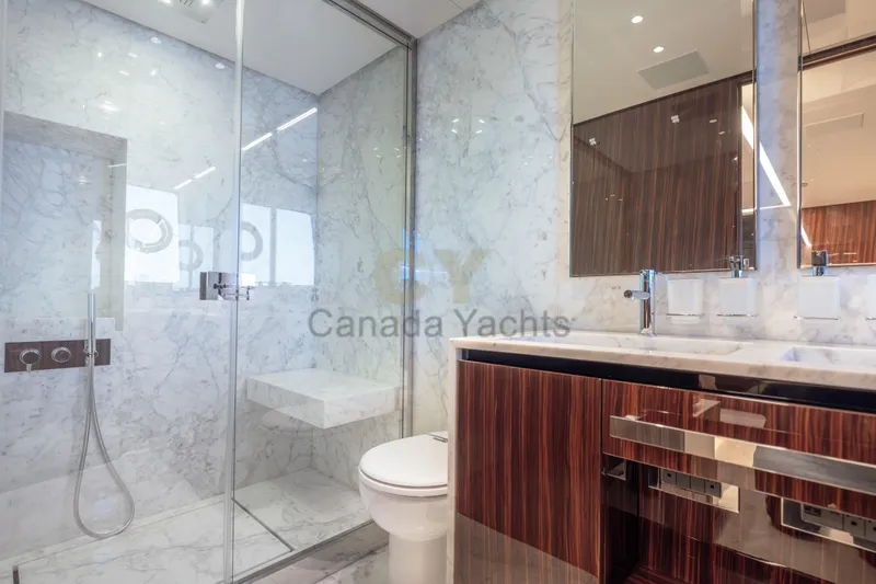 Allora Yacht Photos Pics Luxurious bathroom in 2026 Riva 82' Diva yacht with marble and wood finishes.