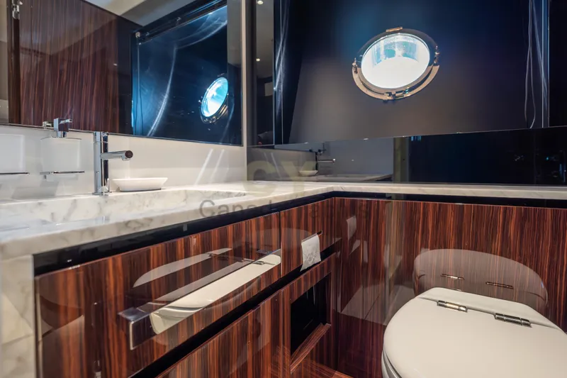 Allora Yacht Photos Pics Luxurious bathroom interior on 2026 Riva 82' Diva yacht with elegant wood finish.