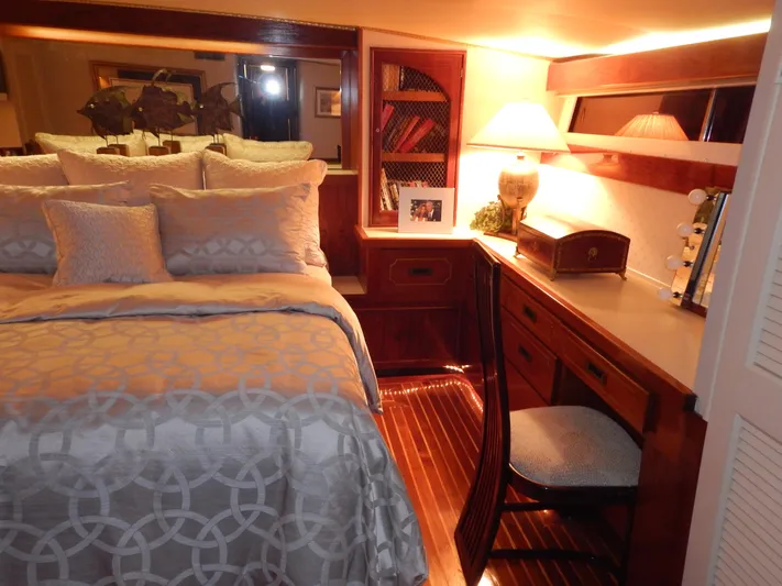 Top Coat Yacht Photos Pics Luxurious 1974 Pacemaker Cockpit Motoryacht bedroom with elegant decor and wooden furnishings.