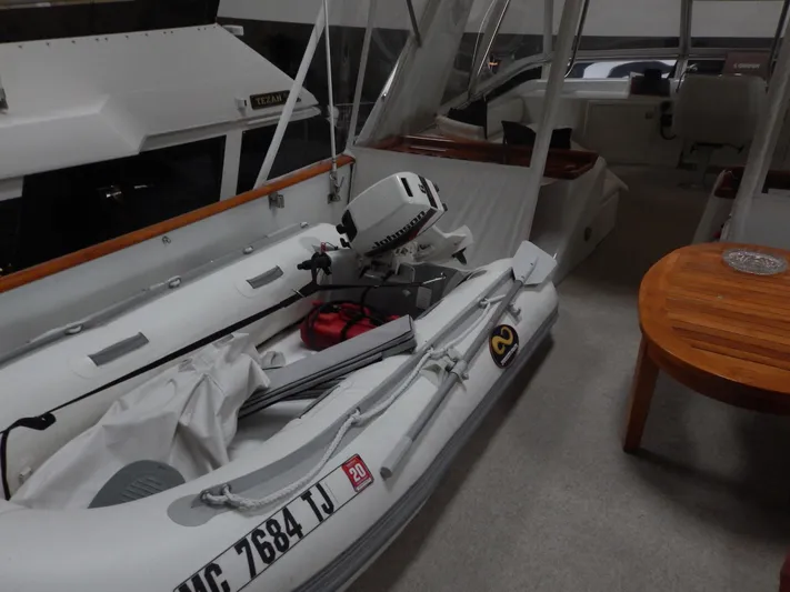 Top Coat Yacht Photos Pics 1974 Pacemaker Cockpit Motoryacht with inflatable boat and outboard motor on deck.