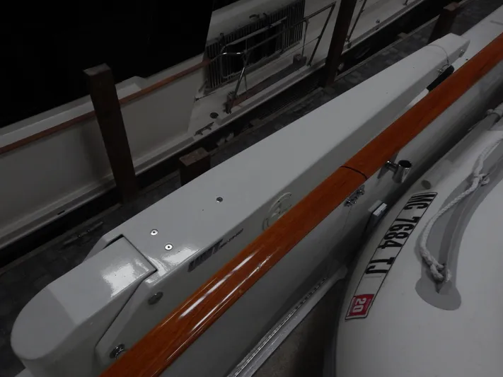 Top Coat Yacht Photos Pics 1974 Pacemaker Cockpit Motoryacht with wooden railings and lifeboat, docked in a marina.