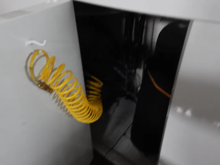 Top Coat Yacht Photos Pics 1974 Pacemaker Cockpit Motoryacht interior with yellow coiled hose and storage compartment.