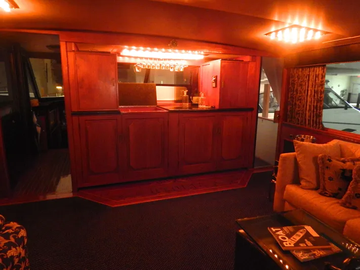 Top Coat Yacht Photos Pics 1974 Pacemaker Cockpit Motoryacht interior with elegant wooden bar and cozy seating area.