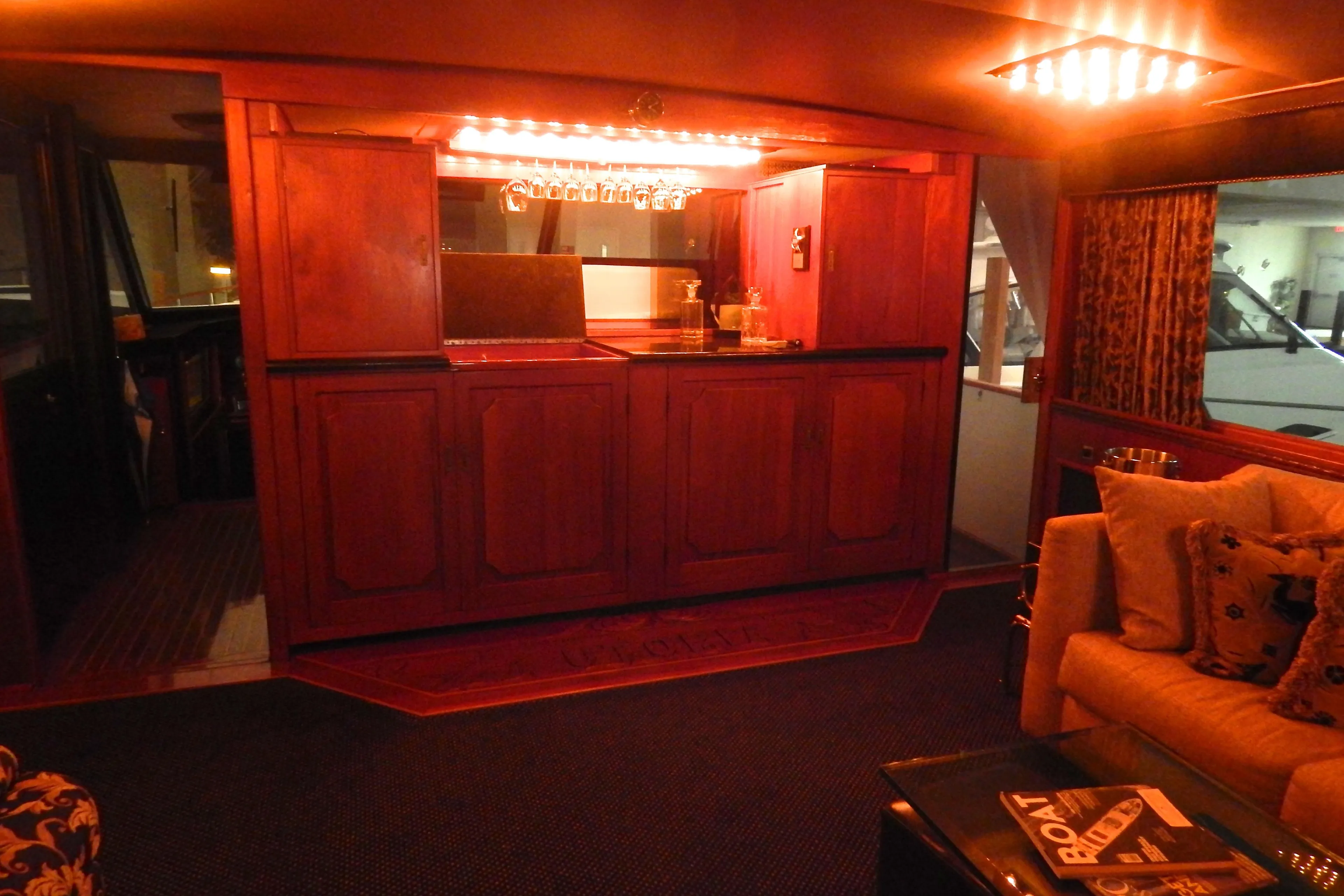 1974 Pacemaker Cockpit Motoryacht interior with elegant wooden bar and cozy seating area.