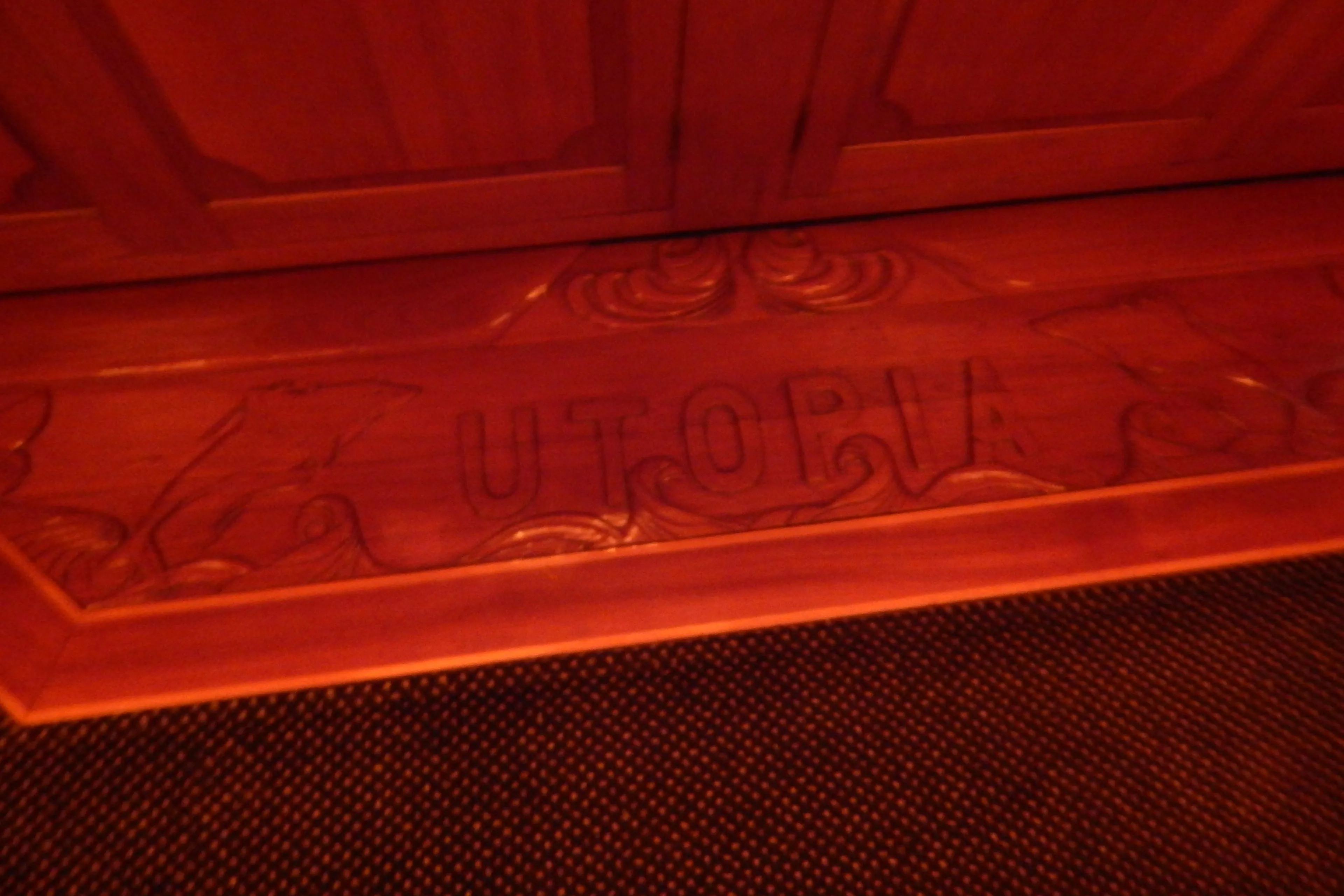 Carved wooden panel with "UTOPIA" on a 1974 Pacemaker Cockpit Motoryacht.