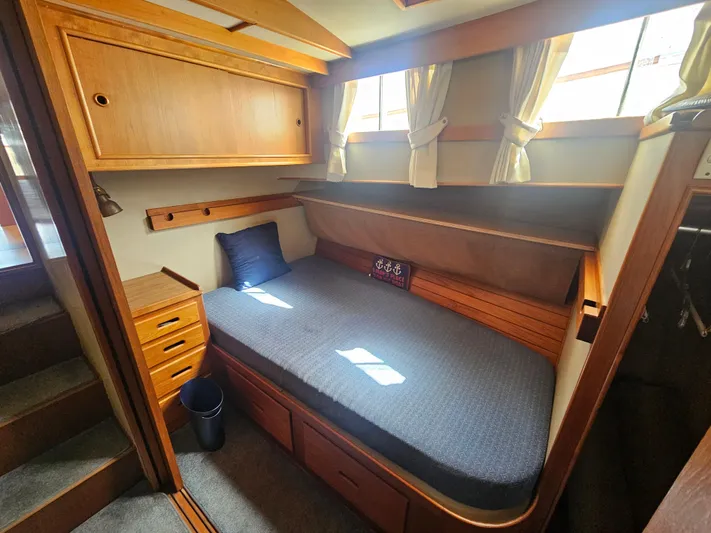 Marytime Yacht Photos Pics Cozy cabin interior of 1987 Grand Banks 42 Europa with wooden furnishings and a single bed.