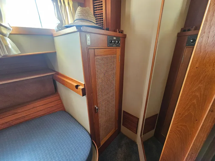 Marytime Yacht Photos Pics 1987 Grand Banks 42 Europa cabin interior with wooden cabinetry and seating.