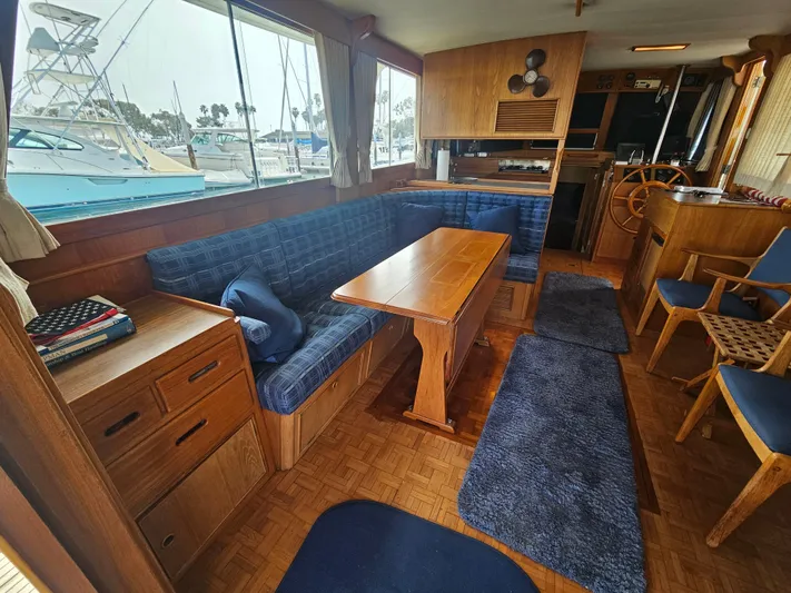 Marytime Yacht Photos Pics Interior of 1987 Grand Banks 42 Europa yacht with blue seating and wooden furnishings.