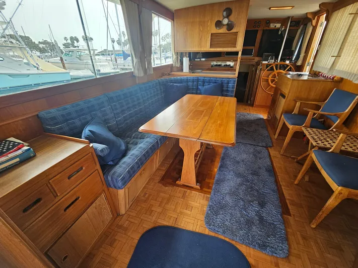Marytime Yacht Photos Pics Interior of 1987 Grand Banks 42 Europa yacht with wooden furnishings and blue upholstery.