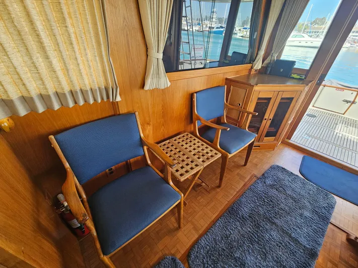 Marytime Yacht Photos Pics Interior of 1987 Grand Banks 42 Europa yacht with blue chairs and wooden accents.