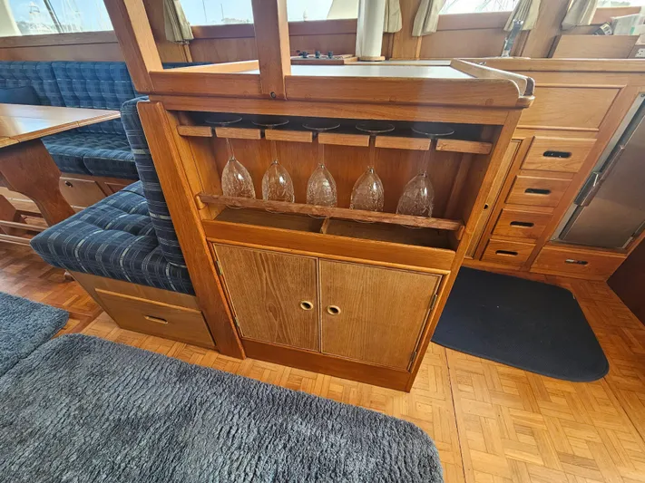 Marytime Yacht Photos Pics Interior of 1987 Grand Banks 42 Europa yacht with wooden cabinetry and glassware storage.