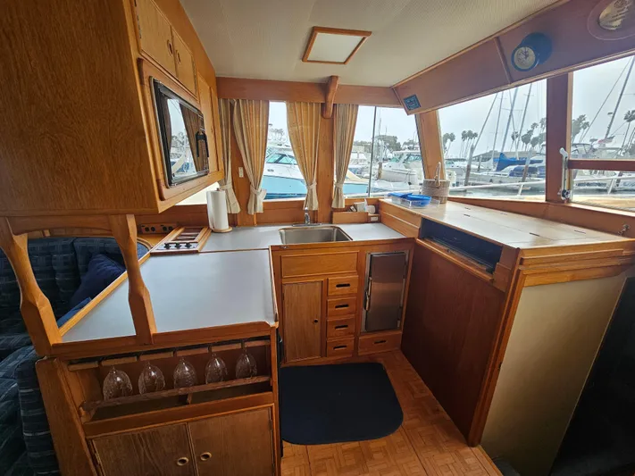 Marytime Yacht Photos Pics Interior of 1987 Grand Banks 42 Europa yacht with wooden cabinetry and marina view.