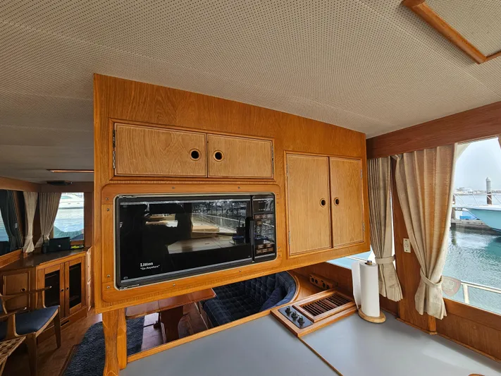 Marytime Yacht Photos Pics Interior of 1987 Grand Banks 42 Europa yacht with wooden cabinetry and microwave.
