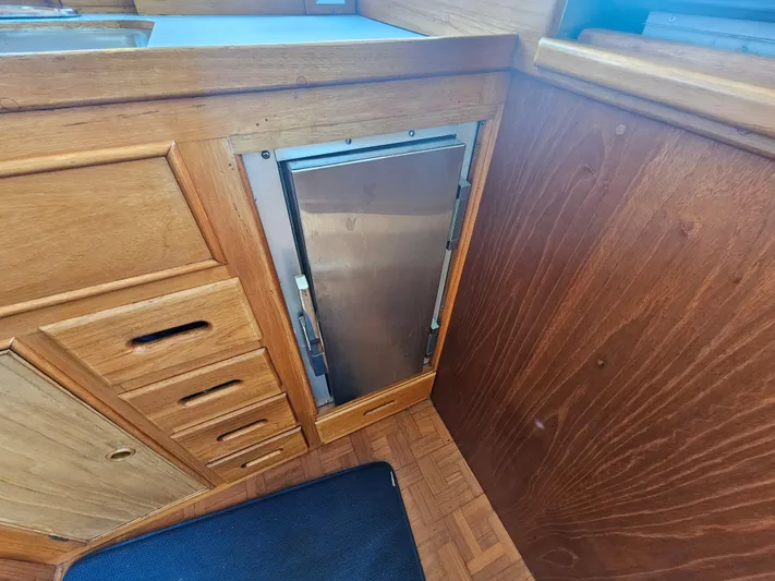 Marytime Yacht Photos Pics Wooden interior of 1987 Grand Banks 42 Europa yacht with built-in storage.