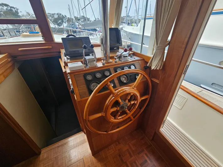 Marytime Yacht Photos Pics 1987 Grand Banks 42 Europa helm with wooden wheel and navigation instruments.