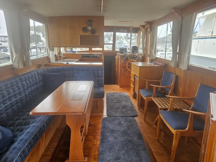 Marytime Yacht Photos Pics Interior of 1987 Grand Banks 42 Europa yacht with wooden furnishings and blue upholstery.