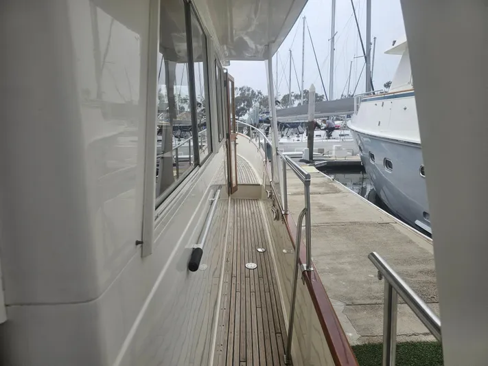 Marytime Yacht Photos Pics 1987 Grand Banks 42 Europa yacht docked, showcasing side deck and marina view.