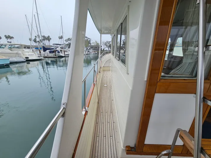 Marytime Yacht Photos Pics 1987 Grand Banks 42 Europa yacht docked at marina, showcasing side deck and railing.