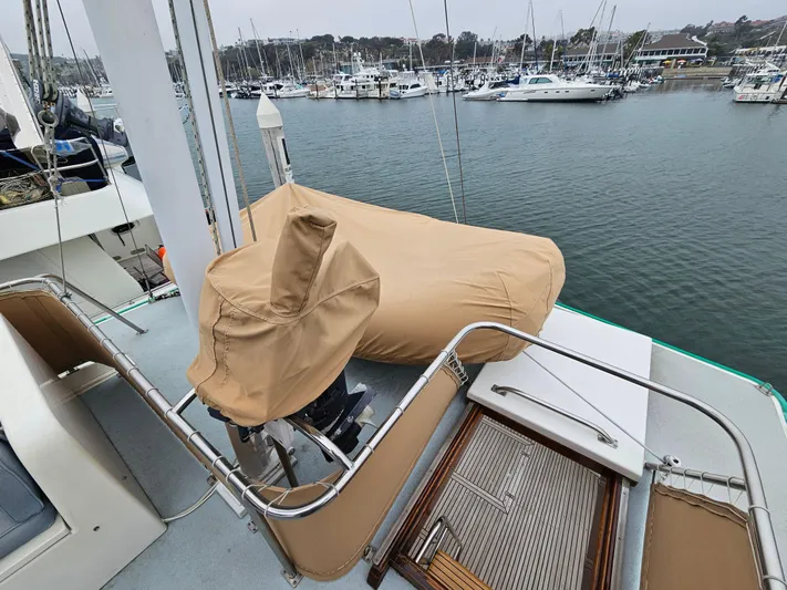 Marytime Yacht Photos Pics 1987 Grand Banks 42 Europa yacht deck with covered equipment, docked in a marina.