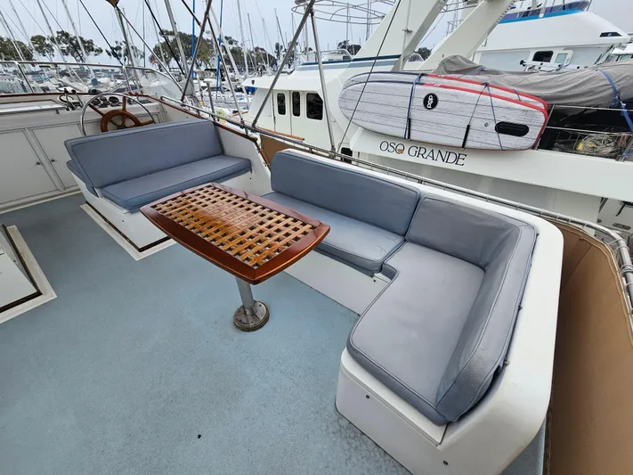 Marytime Yacht Photos Pics 1987 Grand Banks 42 Europa yacht deck with cushioned seating and wooden table.