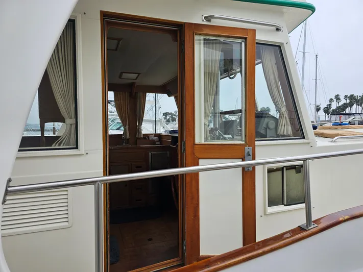 Marytime Yacht Photos Pics 1987 Grand Banks 42 Europa yacht, open cabin door, marina background.